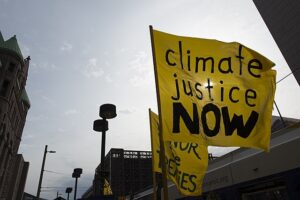 Yellow flag with Climate Justice Now written
