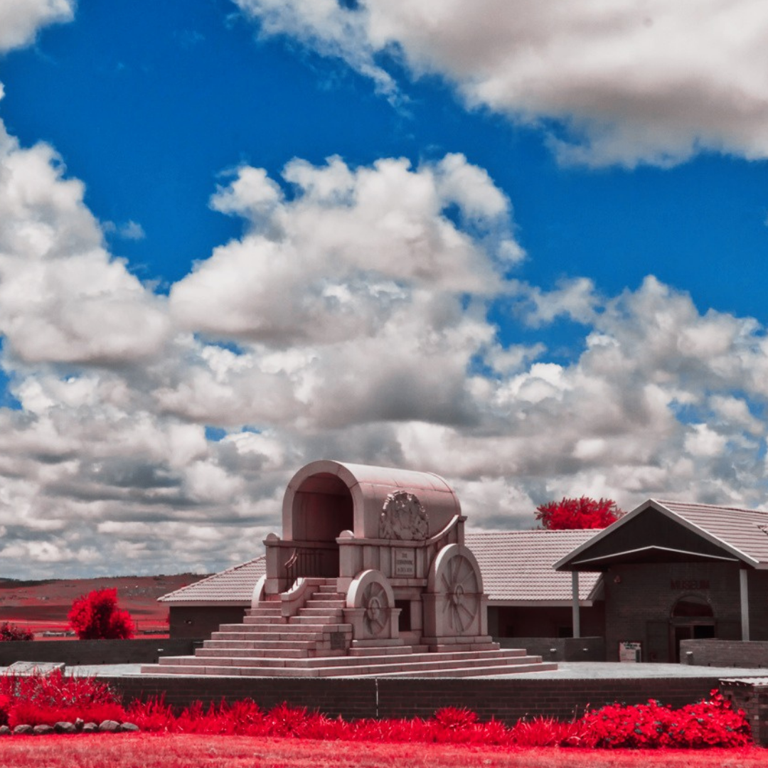 One of the blood river monuments, framed by the sky, features an open stone wagon as an entry.