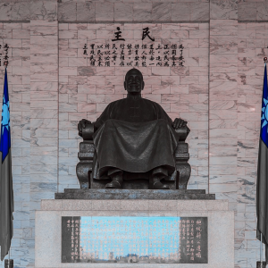 Statue of Chiang sitting cross legged with two Taiwan flags on either side